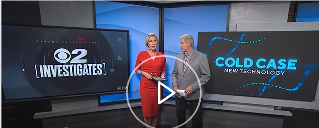 Screen cap from KUTV showing news anchors standing between two large screen monitors