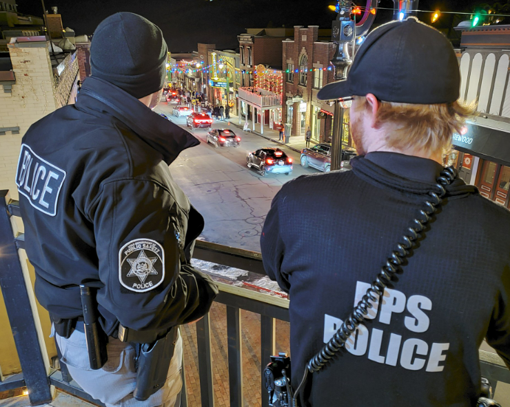 Members of the Alcohol Enforcement Team stand on a balcony overlooking the main street in Park City