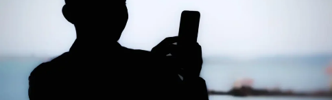 Silhouette of a person using a phone